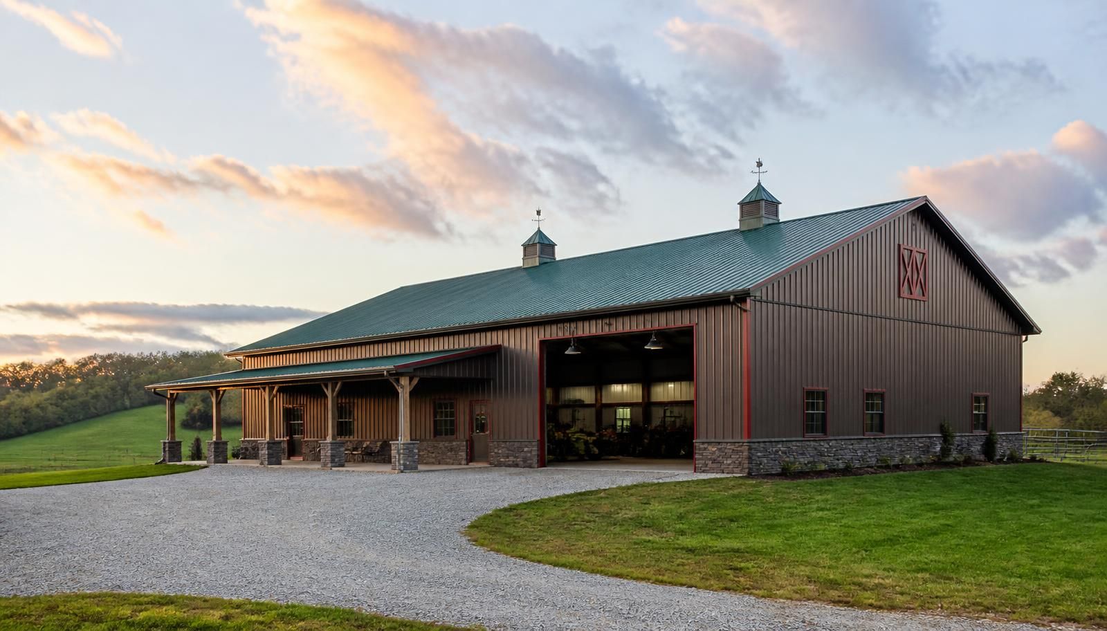 Custom pole barn with green metal roof and red trim on a rural property near Owensboro, Kentucky